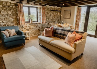 Beams and exposed stonework enhance the reception room